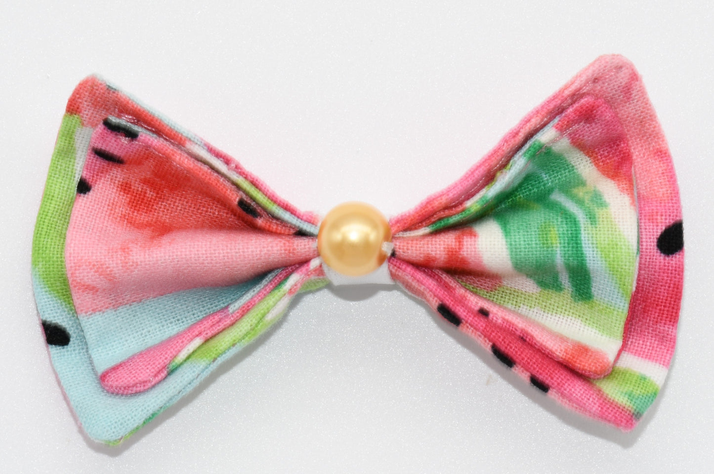 a closeup of the pet hairbow with gold pearl