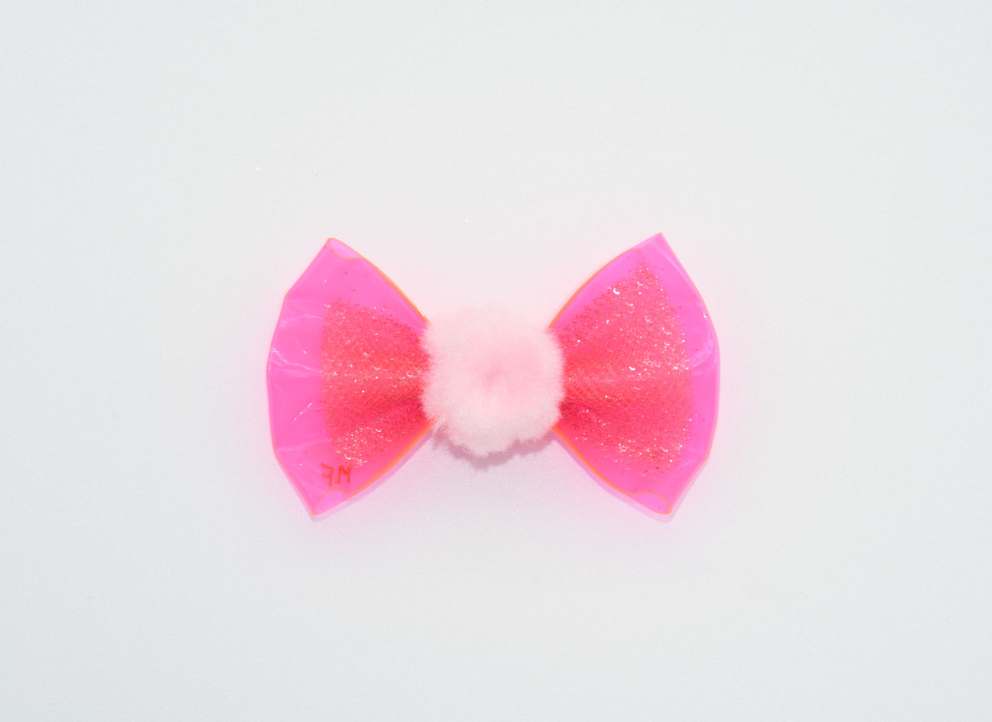 a pink vinyl pet hairbow with a pom pom