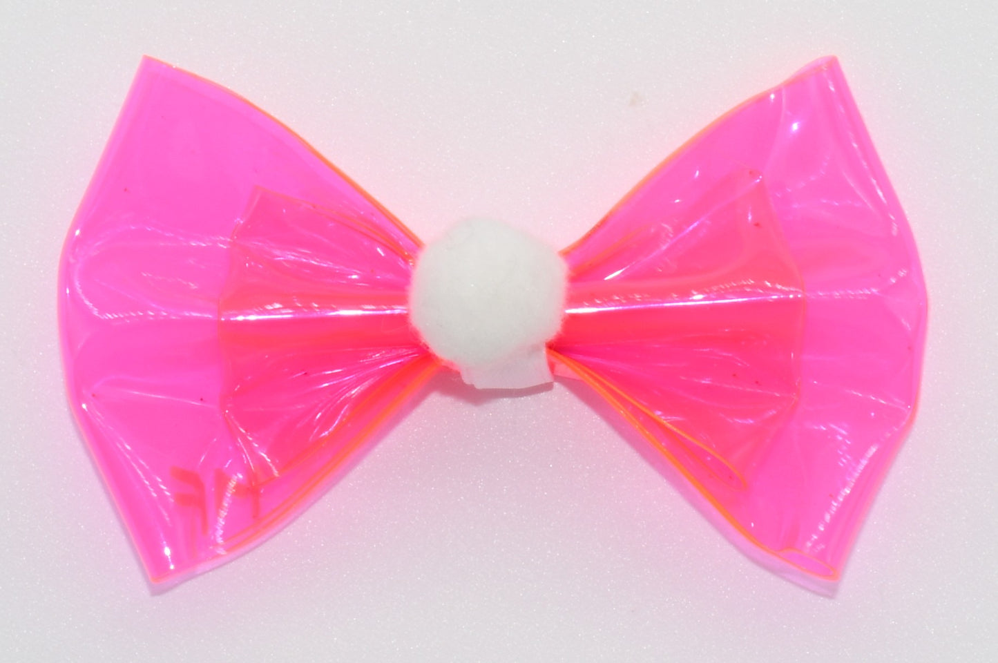 a close up of the pink hairbow with pom pom