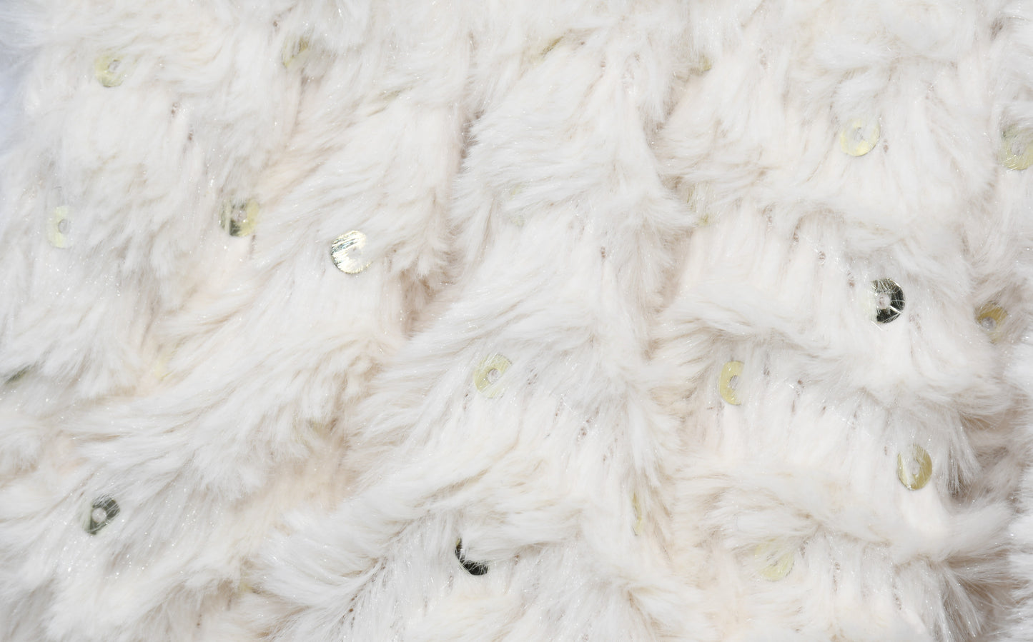 A closeup at the fur and sequin fabric