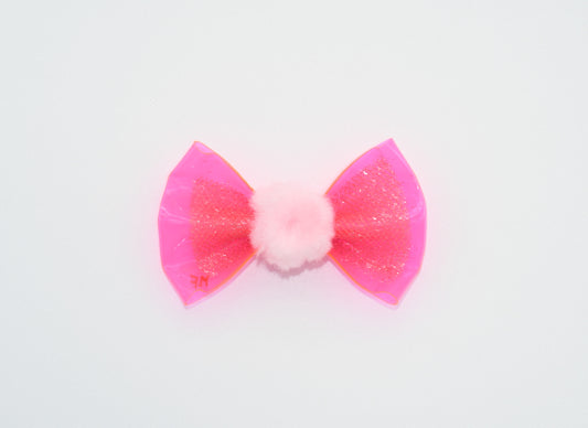 a pink vinyl pet hairbow with a pom pom 