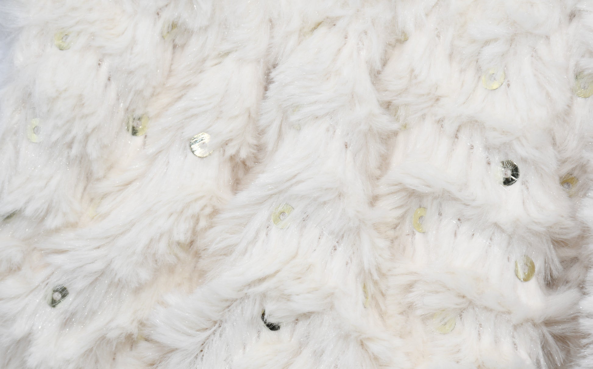 A closeup at the fur and sequin fabric